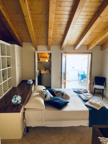 a large bed in a room with a wooden ceiling at Sweet Dream House in Carloforte