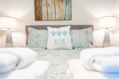 a bedroom with a bed with pillows and two lamps at Beautiful Updated 2Bedroom Suite minutes to Downtown, Amazing Beaches, Restaurants, Theaters and MORE in Sarasota