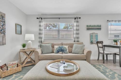 a living room with a couch and a table at Beautiful Updated 2Bedroom Suite minutes to Downtown, Amazing Beaches, Restaurants, Theaters and MORE in Sarasota