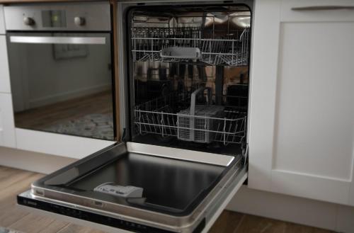 a dishwasher with its door open in a kitchen at Superbe appartement - L'escapade in Onzain