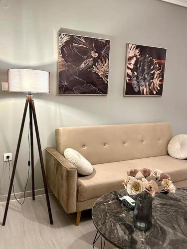 a living room with a couch and a table at yourcomfortzone*VOLOS in Volos