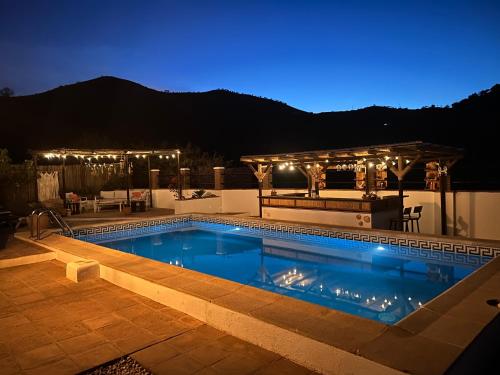 a swimming pool at night with a gazebo at Casa LIMA in Viñuela