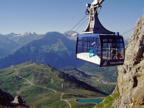a gondola is flying over a mountain at Bacherhof in Sankt Anton am Arlberg