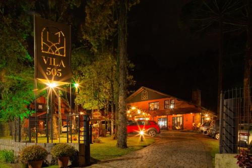 a sign that reads villa on a street at night at Pousada Vila 505 in Canela