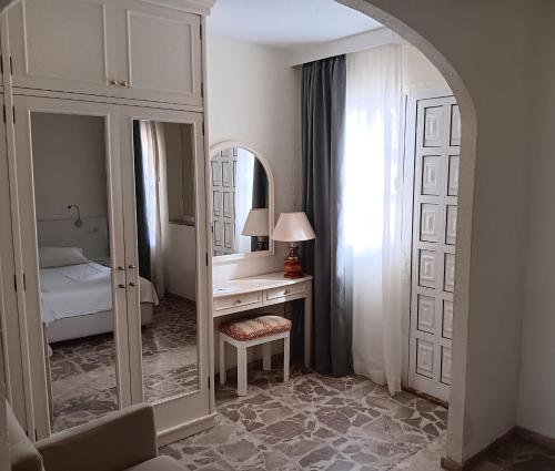 1 dormitorio con tocador y espejo en Bungalows Club Primavera, en Playa del Inglés