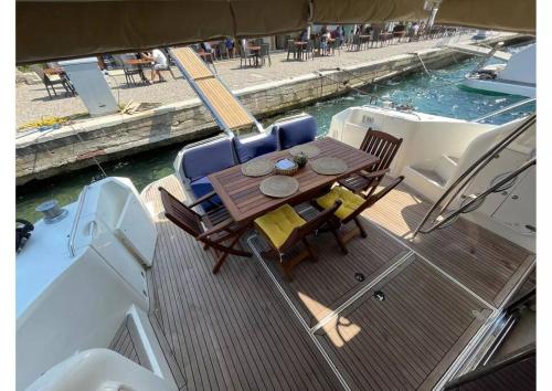 a deck with a table and chairs on a boat at Bodrum Yacht Rental in Yalikavak in Bodrum City