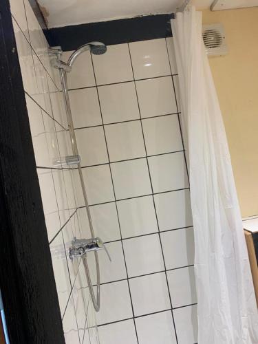 a shower in a bathroom with a shower curtain at One Lovely Apartmt 1 Double & 2 Camp Beds in Stoke on Trent