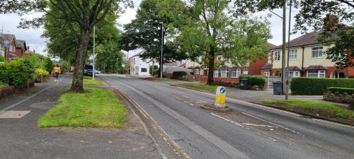 an empty street in a residential neighborhood with houses at One Lovely Apartmt 1 Double & 2 Camp Beds in Stoke on Trent