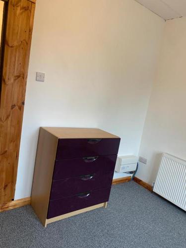 an empty room with a dresser in a room at One Lovely Apartmt 1 Double & 2 Camp Beds in Stoke on Trent