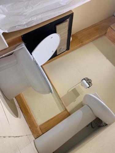 a toilet in a small room with a counter at One Lovely Apartmt 1 Double & 2 Camp Beds in Stoke on Trent