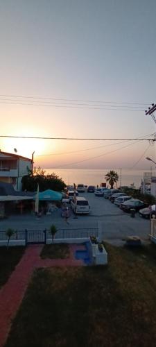 a parking lot with cars parked in a parking lot at Mana mia Seaside Apartments in Leptokaria