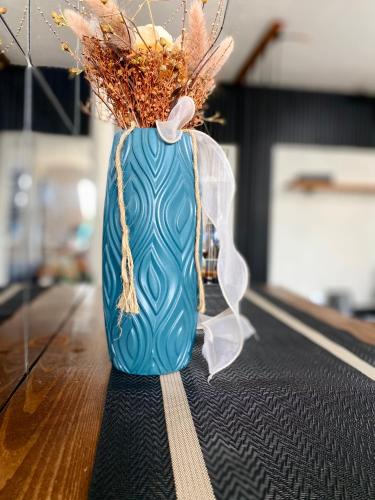 a blue vase sitting on top of a table at Casa Cabilao Staycation in Santa Rosa