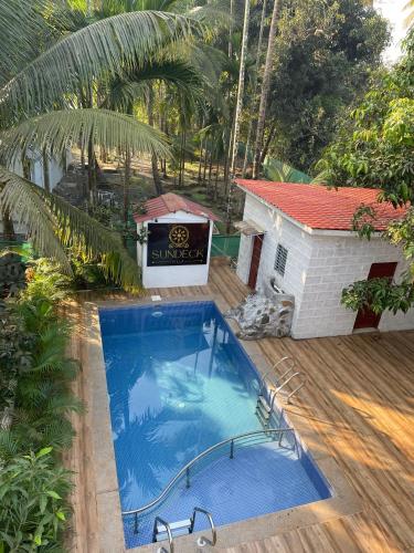 an overhead view of a swimming pool next to a house at Sundeck Villa in Alibaug