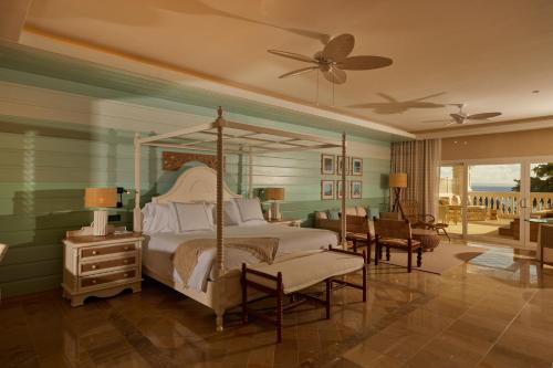 a bedroom with a canopy bed and a patio at Cayo Levantado Resort - All Inclusive in Santa Bárbara de Samaná