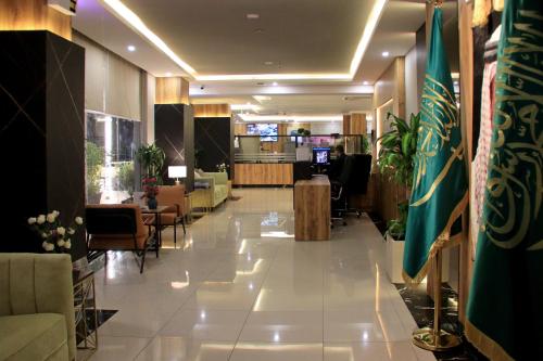 a lobby with tables and chairs in a building at شقق سوات للشقق المخدومة 4 in Al Khobar