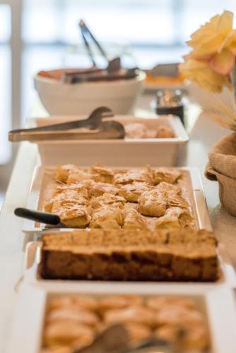 a table topped with cakes and other food items at Luxury Villa Muse Calliope in Matala