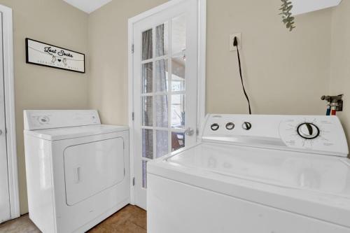 a white laundry room with a washer and dryer at Two Spaces in One Main House and Guest House 25 Min to PCB in Panama City