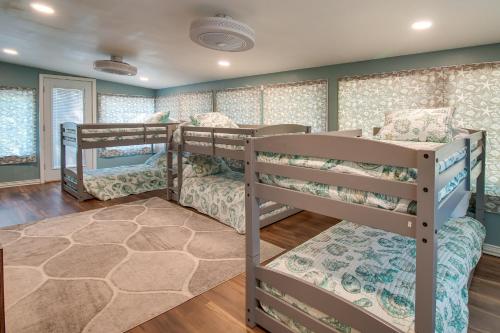 a bedroom with three bunk beds in a room at Cookson Vacation Rental with Spacious Yard and Porch! in Cookson