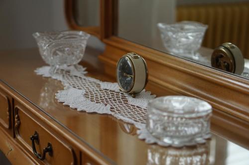 a wooden dresser with glasses and a mirror at Rheinblick am Rheinsteig mit Balkon und Sauna in Urbar-Mayen-Koblenz