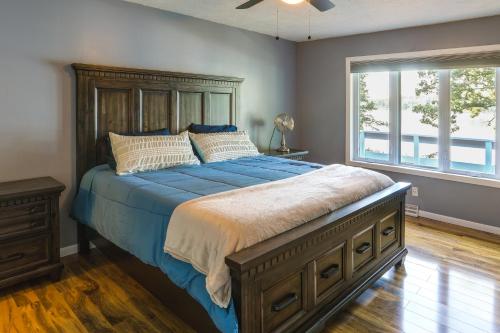 a bedroom with a large bed and a window at Lakefront Arkansas Escape with Grill, Dock and Kayaks! in Horseshoe Bend