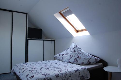 a bedroom with a bed with a pillow on it at Penzion Levandule in Rumburk