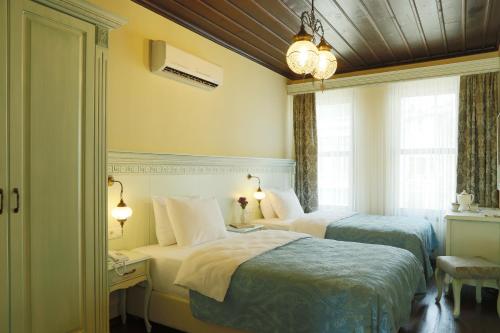 ブルサにあるブルサ イペックヨル ホテルのベッド2台と窓が備わるホテルルームです。