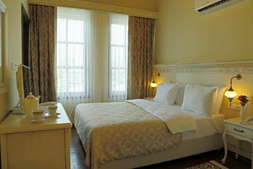 Postel nebo postele na pokoji v ubytování Bursa İpekyolu Hotel