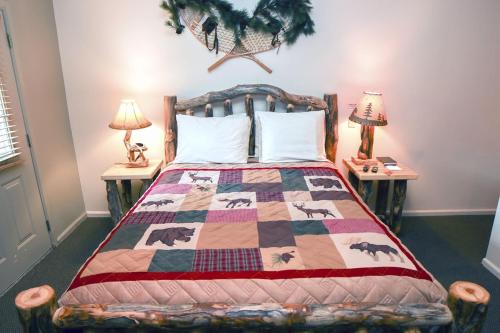 a bedroom with a bed with a horse quilt on it at Fawn Valley Inn- 106 condo in Estes Park