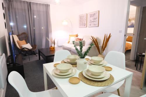 a living room with a white table and chairs at Richmond Village Apartments in Cardiff