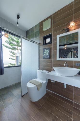 a bathroom with a toilet and a sink at The Proud Resort @Khao kho in Khao Kho
