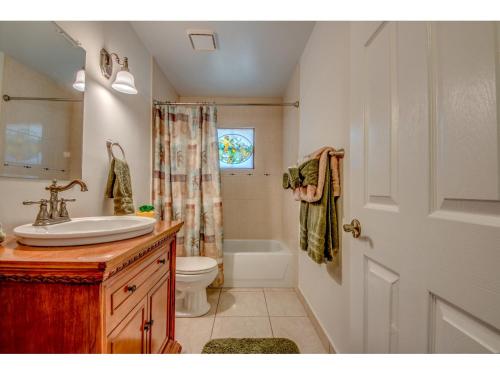 a bathroom with a sink and a toilet and a shower at Villa Hideaway, Cape Coral in Cape Coral