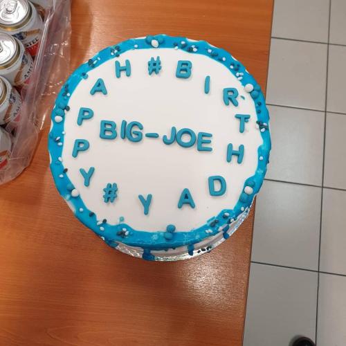 a blue and white birthday cake on a table at Mexiloyd Luxury Rooms & Suites in Port Harcourt