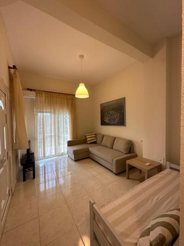 a living room with a couch and a table at Venice Studios & Apartments in Stavros