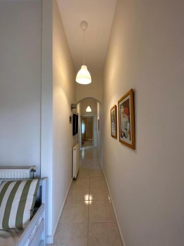 a hallway leading to a room with a bed and a hallway at Venice Studios & Apartments in Stavros