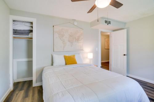 a white bedroom with a large bed and a ceiling fan at Kimberling City Escape with Dock Access and Boat Slips in Kimberling City
