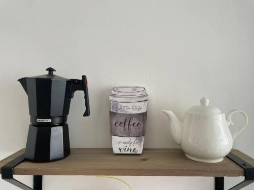a coffee maker and a blender on a wooden shelf at Brand new, with private Jacuzzi in Carlos Guerra