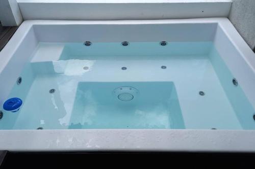 a bathtub filled with water in a room at Brand new, with private Jacuzzi in Carlos Guerra