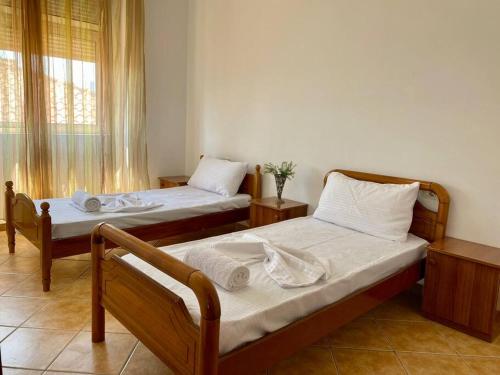 a bedroom with two beds and a window at Roel apartments Shkodra Center in Shkodër
