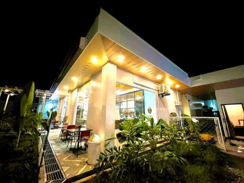 a house with a patio at night with lights at E&R Airport Hotel in Dumaguete