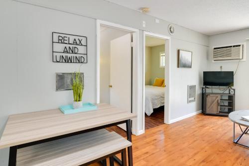 a living room with a table and a bedroom at Lakefront Oasis Boat Slip, Kayaks and Outdoor Pool in Kimberling City