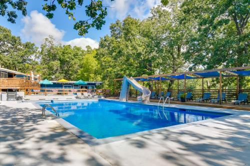a swimming pool with a slide in a resort at Lakefront Oasis Boat Slip, Kayaks and Outdoor Pool in Kimberling City