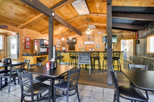 a restaurant with tables and chairs and a bar at Lakefront Oasis Boat Slip, Kayaks and Outdoor Pool in Kimberling City