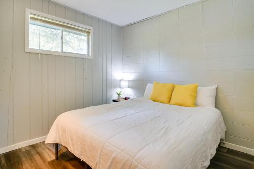 a bedroom with a large white bed with yellow pillows at Kimberling City Oasis Boat Slip, Kayaks and More! in Kimberling City