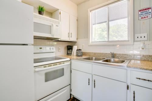 a white kitchen with white appliances and a sink at Kimberling City Oasis Boat Slip, Kayaks and More! in Kimberling City