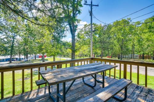 a wooden bench on a deck with a fence at Kimberling City Oasis Boat Slip, Kayaks and More! in Kimberling City