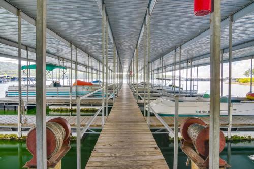 a dock with several boats in the water at Kimberling City Oasis Boat Slip, Kayaks and More! in Kimberling City