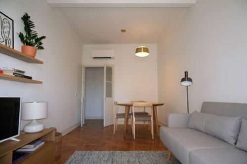 a living room with a couch and a table at Charming apartment by the river in Alcácer do Sal