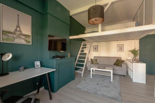 a living room with a loft bed and a desk at Le Franklin in Saint Etienne