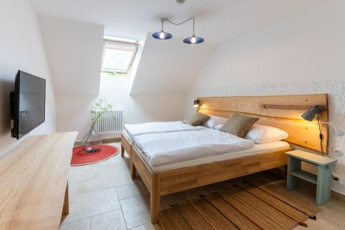 - une chambre avec un lit et une tête de lit en bois dans l'établissement Hotel Lechowitz, à Lechovice