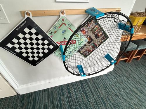 a tennis racket is hanging on a wall at YHA Whitby in Whitby